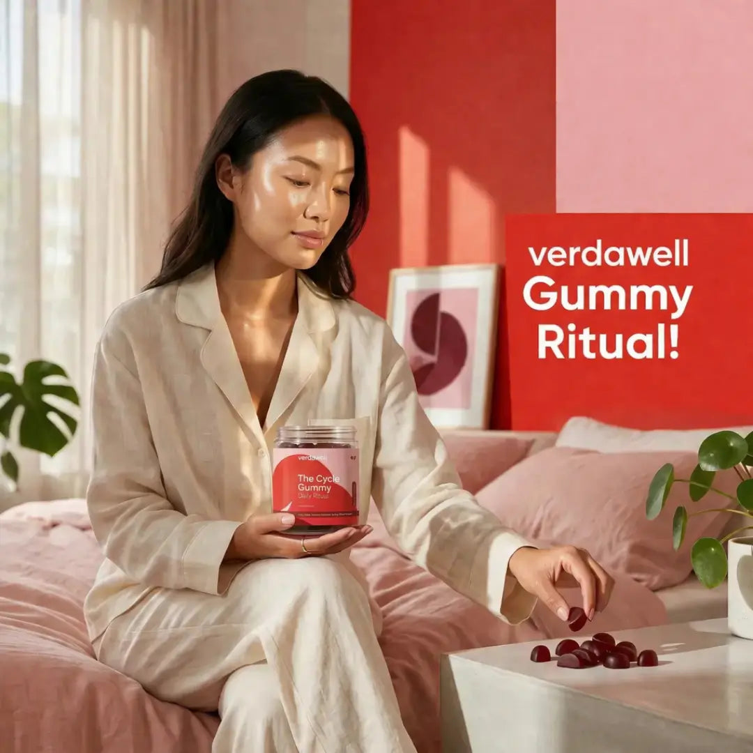 Woman in cream robe holding Verdawell The Cycle Gummy jar during her morning wellness ritual